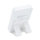 A white electronic device with a stand, viewed from the back.