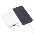 A smartphone connected to a white portable power bank with charging cables.