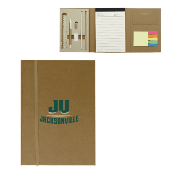 A brown stationery set with JU Jacksonville on the cover. Inside, it contains a ruler, pencil, eraser, sharpener, pen, notepad, sticky notes, and colored flags. The items are neatly arranged in a cardboard folder.