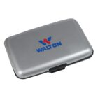 A silver card holder with a black latch and the word WALTON in blue, accompanied by a red and blue logo, centered on the lid.