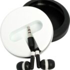 A pair of black and white earphones with a 3.5mm jack rests inside a round black and white case. The earphones are connected and neatly placed in the case, which is partially open.