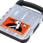 A black and transparent plastic toolbox with a hinged lid, featuring a logo of a drill and hammer with Tradiewebsite on an orange background. Inside are organized compartments for various tools.