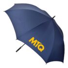 A large, open navy blue umbrella with the yellow letters MTQ printed on one panel. The umbrella has a black handle and is displayed against a plain white background.