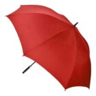 A large, open red umbrella with a black handle is displayed against a white background. The umbrella is tilted slightly to the right, showcasing its fabric and structure.