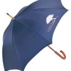 A blue umbrella with a curved wooden handle and a logo of a tree with the text Goliath Golf printed in white on one panel.