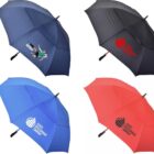 Four umbrellas arranged in a grid: top left is navy with a golfer image, top right is black with a red logo, bottom left is blue with a white logo, and bottom right is red with a black logo.