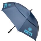 A large, blue umbrella with a black handle is fully opened. It features the word VORTEX and a swirling design in light blue on two panels. The umbrellas canopy is spacious and slightly tilted in the image.