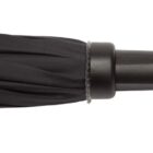 A close-up of a black, closed umbrella, showing the top section with neatly wrapped fabric around a black tip. The umbrella is lying horizontally against a white background.