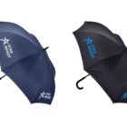 Two umbrellas with Star Invest logos, one navy blue and the other black, are displayed against a white background. Both have curved black handles.