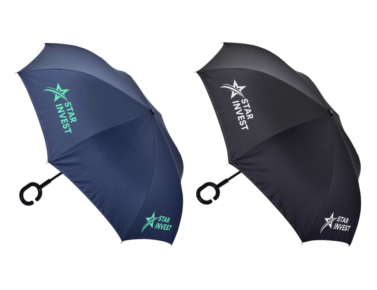 Two umbrellas are displayed against a white background. One is dark blue, and the other is black. Both have Star Invest logo printed in white and green on their canopies. They feature a C-shaped handle.