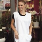 A woman wearing a white apron over a black shirt stands in front of a flower shop with decorative plants and flowers visible through the glass. The word HOSPITALITY is written at the bottom, and a BOCINI logo is at the top left corner.