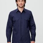 A person with long hair is wearing a long-sleeved, dark blue button-up shirt with two chest pockets, standing against a plain background.