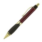 A ballpoint pen with a shiny metallic red barrel, gold accents, and a black rubber grip. The pen is positioned diagonally with the tip pointing to the bottom left.