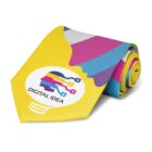 A rolled necktie with a vibrant design featuring a stylized light bulb graphic. The bulb is composed of colorful, interconnected digital lines and the words Digital Idea are written inside. The tie has a yellow, pink, blue, and gray color scheme.