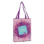 A pink tote bag with purple handles features a floral design. The center has a purple circle with flower garden text inside a blue square. The floral pattern includes various shades of pink and lavender flowers around the circle.