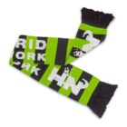 A knitted scarf featuring bold green and black stripes with white letters spelling GRID NETWORK and pixelated designs, including a white car icon. Black fringes adorn both ends of the scarf.
