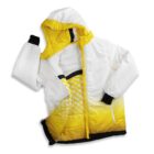 A jacket with a white and yellow gradient design is laid flat. It features a hood, zipper closure, black cuffs, and a crisscross pattern on the inner lining.