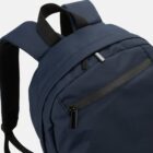 Navy blue backpack with a front zip pocket and black straps.
