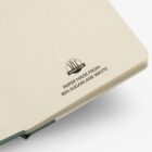 Open notebook with text stating Paper made from 80% sugarcane waste on the inside cover.