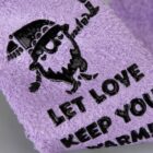 Purple textured fabric with a bearded cartoon and the text: LET LOVE KEEP YOU WARM.
