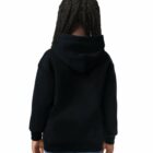 A child with braided hair wears a black hoodie and blue jeans, facing away from the camera.