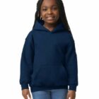 Smiling girl wearing a navy blue hoodie and jeans, standing against a white background.