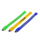 Three colorful USB bracelets: green, yellow, and blue with different printed text.