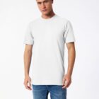 A person in a plain white T-shirt and blue jeans stands against a white background, looking at the camera with a neutral expression.
