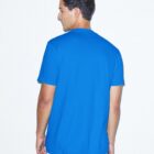 A person with short dark hair is standing and facing away, wearing a bright blue T-shirt and light gray pants against a plain white background.