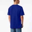 A person wearing a plain blue T-shirt and jeans is standing with their back to the camera. The background is plain white, emphasizing the clothing.