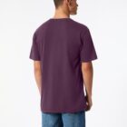 A person wearing a purple T-shirt and blue jeans is standing with their back to the camera against a plain white background.
