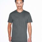 A person with short curly hair and a mustache is wearing a plain dark green t-shirt standing against a white background. They have a relaxed expression, with one hand partially visible by their side.