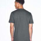 A person with short curly hair, viewed from the back, wearing a dark gray T-shirt and light-colored pants against a plain white background.