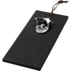 Wall-mounted metal bottle opener on a black rectangular wooden board with a leather loop.