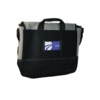 Black and gray tote bag with handles and a front pocket holding a notecard.