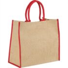 A jute tote bag with red handles and red edges.