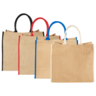 Four jute tote bags with red, blue, black, and white handles and edges, lined up.