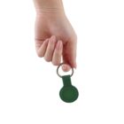 Hand holding a green keychain against a white background.