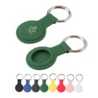 Green and various colored round keychains with metal rings, one with YOGA printed on it.