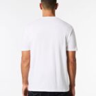 A person wearing a plain white T-shirt and dark jeans is standing with their back facing the camera against a white background.