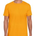 A person wearing a plain orange T-shirt and dark pants is smiling against a plain background.