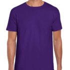 A person wearing a plain purple t-shirt stands with arms at their sides. The t-shirt is short-sleeved and paired with dark pants. The background is plain white.