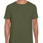 A person wearing a plain olive green T-shirt and dark pants stands against a white background. The T-shirt is short-sleeved and fits comfortably.