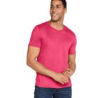 A person wearing a bright pink T-shirt and blue jeans is smiling and looking to the side against a plain white background.