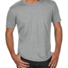 A person wearing a plain gray T-shirt and dark jeans, standing with hands in pockets. The background is white.
