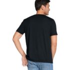 A person wearing a black T-shirt and blue jeans is standing with their back to the camera, looking over their left shoulder. The background is plain white.