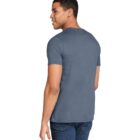 A person is standing and looking over their shoulder, wearing a short-sleeved blue T-shirt and dark jeans. The background is white.