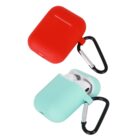 Red and teal AirPods cases with carabiners, one with earbuds inside.