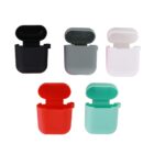 Five colorful earbud cases in black, gray, white, red, and teal, arranged in a pattern.