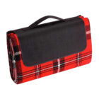 Red plaid picnic blanket rolled up with a black strap and handle.